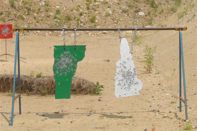 Pistol targets cut out in the shape of Vermont and New Hampshire.